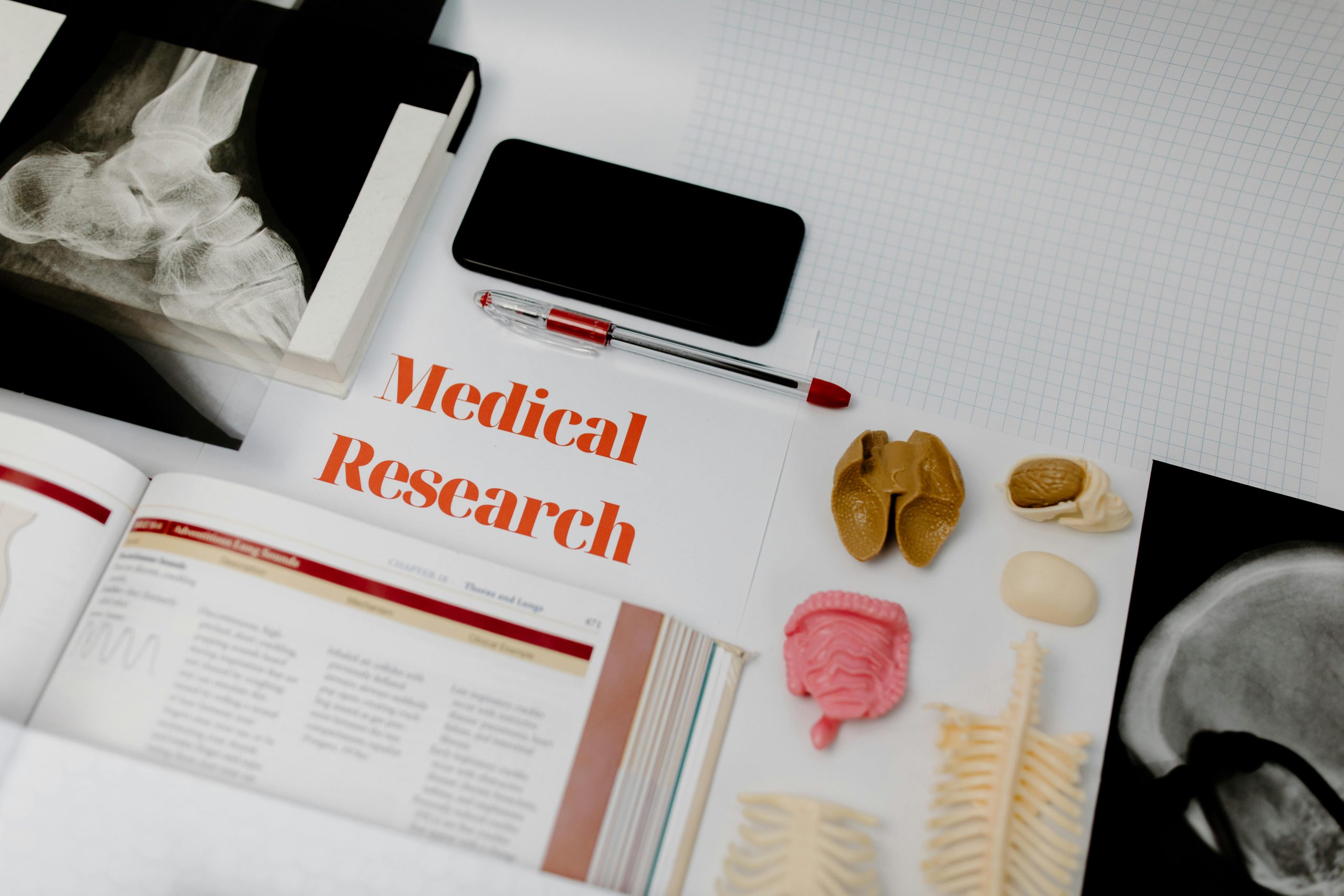 Medical research materials including anatomy models, textbooks, and X-ray images