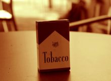 Pack of tobacco cigarettes on a table, symbolizing concerns over tobacco industry funding in scientific research and medical publications