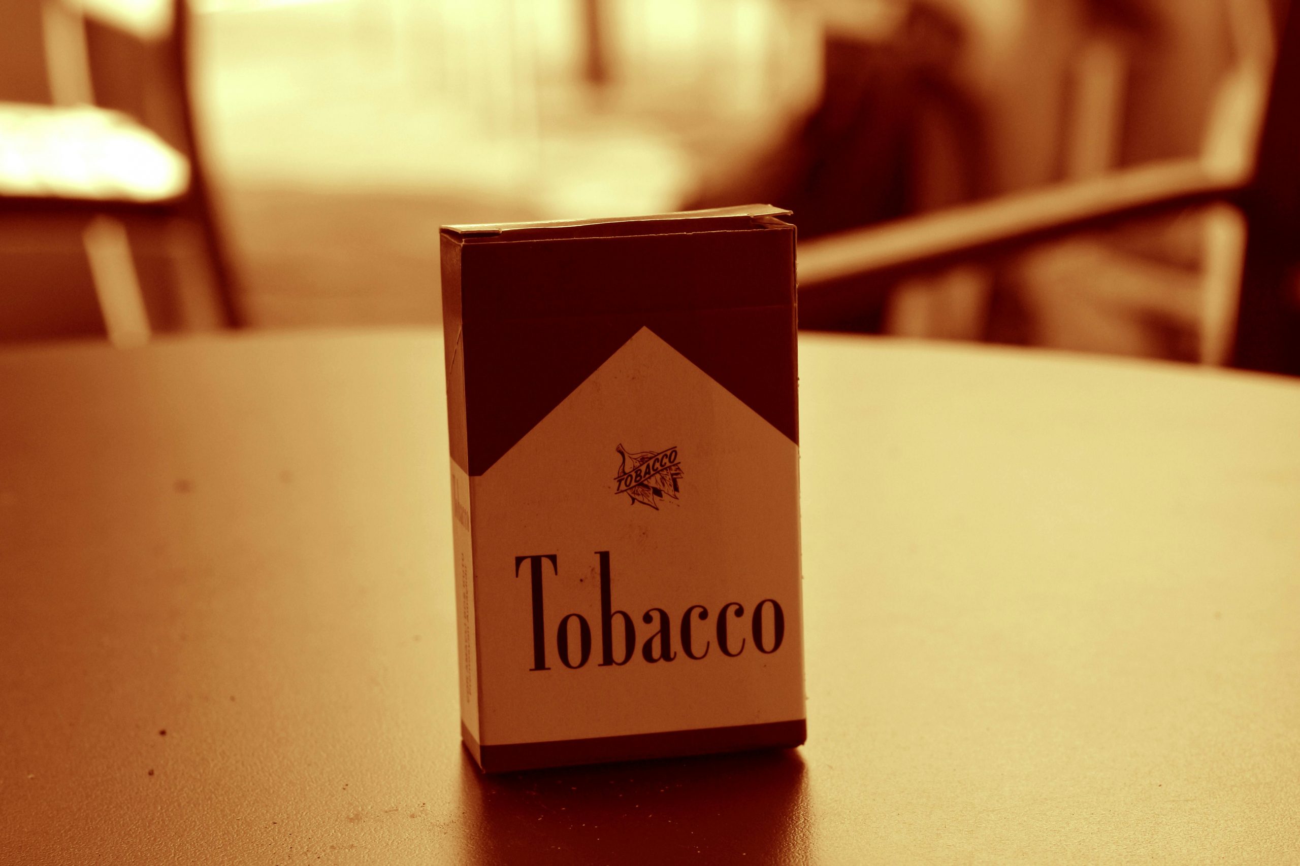 Pack of tobacco cigarettes on a table, symbolizing concerns over tobacco industry funding in scientific research and medical publications