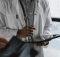 Doctor in white coat holding a tablet, symbolizing the need for affordable medical education and accessible healthcare in India.